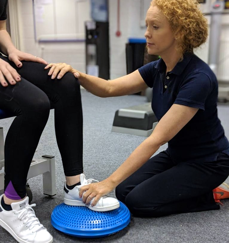 Claire Evans with patient balancing foot