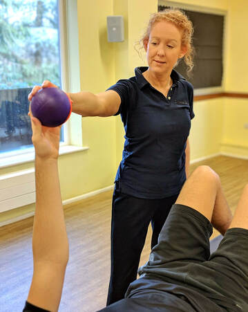 Claire Evans with patient holding small purple ball